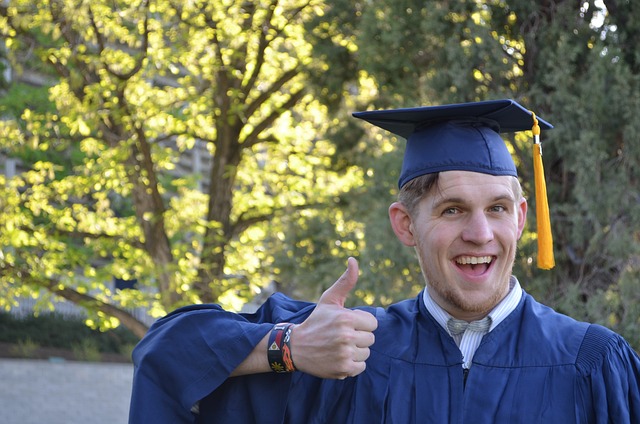 thumbs up male graduate